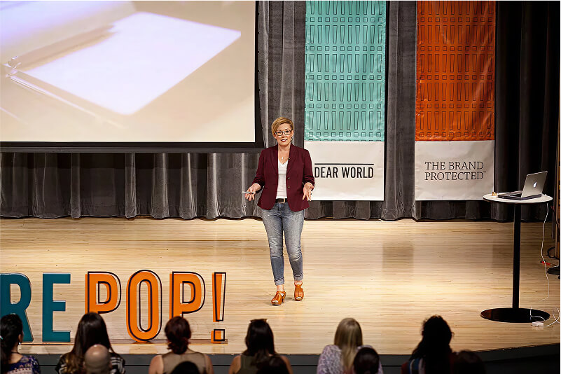 Woman on stage giving a presentation